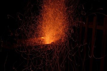 Dynamic burst of orange sparks from metalwork