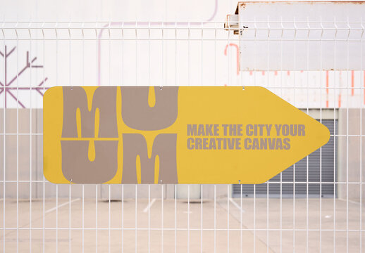 Mockup of Blank Arrow Sign on White Fence Panel