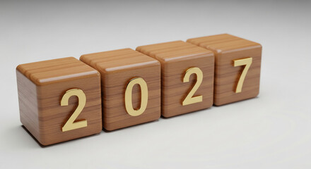 Four wooden blocks showing year 2027 with golden digit, representing future time, date or calendar, laid on neutral surface, planning concept