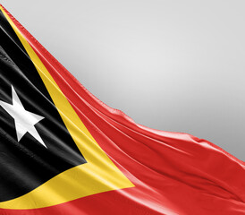 East Timor flag waving on grey background. East Timor nationalflag for independence day.