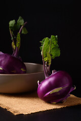 Ripe purple kohlrabi, freshly harvested from an organic farm, placed on a black background, is a healthy ingredient for cooking