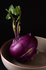 Ripe purple kohlrabi, freshly harvested from an organic farm, placed on a black background, is a healthy ingredient for cooking