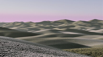 Rolling Sand Dunes Under a Soft Pink Sky at Sunrise or Sunset