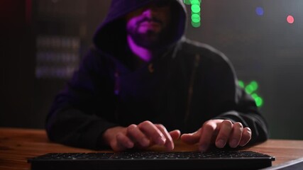 Hooded hacker typing code in a dark server room - Powered by Adobe