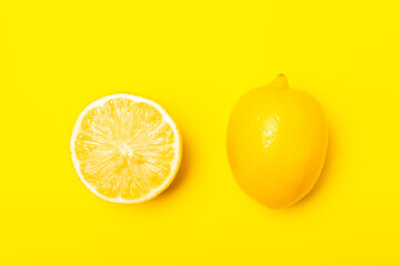 Lemon on a wooden table. Fresh lemon with a slice. Fresh lemon with citrus leaves. Lemon juice. Food and drink ingredients preparing. Healthy eating. Vitamin C. Space for text.