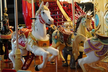 Closeup of horses of colorful carousel for children in Christmas market in Bucharest