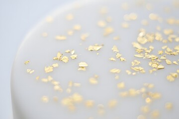 Elegant white surface with scattered gold flakes