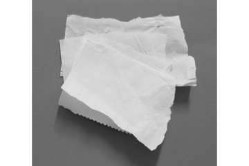 Stack of torn white paper pieces on gray background with copy space for notes, branding design, minimal mockup, abstract paper texture