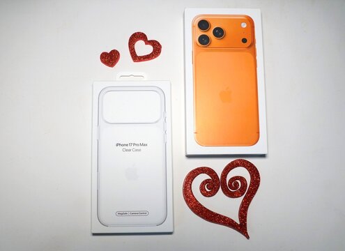 Delaware, U.S.A - Dec 24, 2025 - Clear MagSafe case with camera control next to a brand new iPhone 17 Pro Max, displayed with heart decor for Valentine's Day