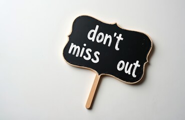 Small blackboard with text dont miss out written on it. Isolated on white background for concept message. Signboard for reminder or announcement.
