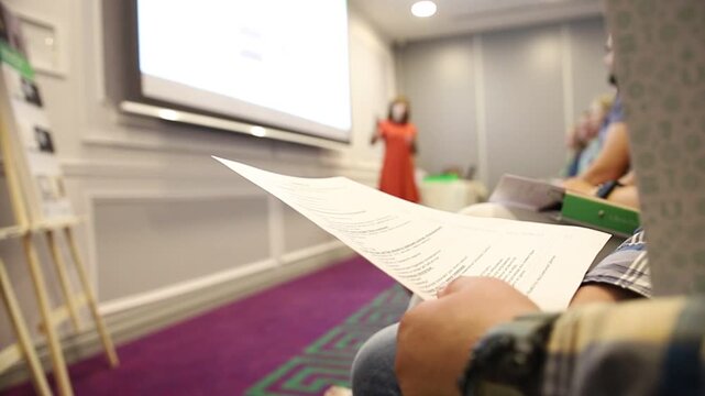 Student reading program during conference presentation - Powered by Adobe