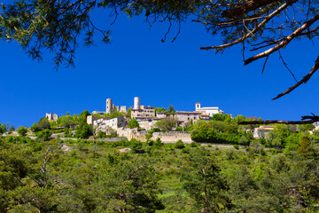 Fototapeta premium The French mountain village of Bargeme, high on a hill, silhouetted against a blue sky
