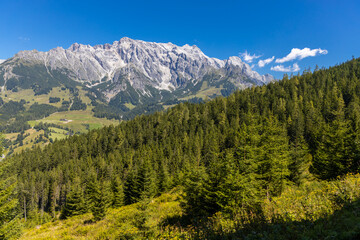 Hochkonig mountain range in Austria. Alps mountains on a sunny day. Mountain landscape. Blue sky with some clouds above beautiful summits alpine range Hochkonig in Austria Tyrol