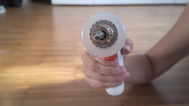 Front view cordless screwdriver tip spinning toward camera