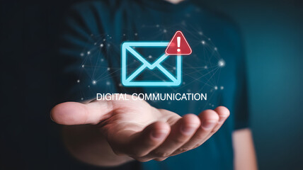 Hand presenting digital envelope icon with red warning triangle and text “DIGITAL COMMUNICATION