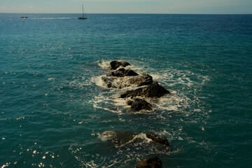 Secluded rocky promontory meeting tranquil sandy shores below