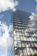 Glass skyscrapers and cloudy blue sky in the background