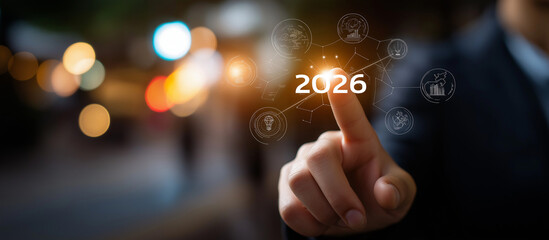 Business roadmap to 2026 success concept heavily defocused background faceless finger pointing at 2026 target surrounded by icons representing innovation sustainability teamwork