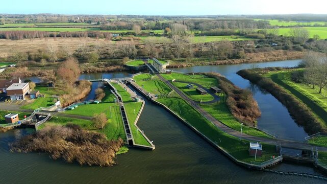 Aerial drone view of inland river canal and water control facility, sluice gates and lock gates, abstraction of water, Denver Sluice complex England UK 