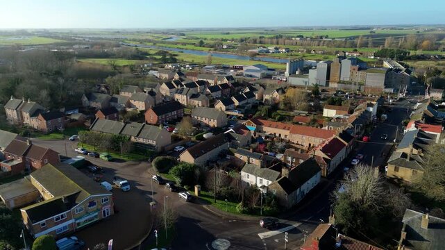 Aerial drone view of Downham Market, residential suburbs and housing in bright winter sunlight. cars parked outside houses. United Kingdom.  