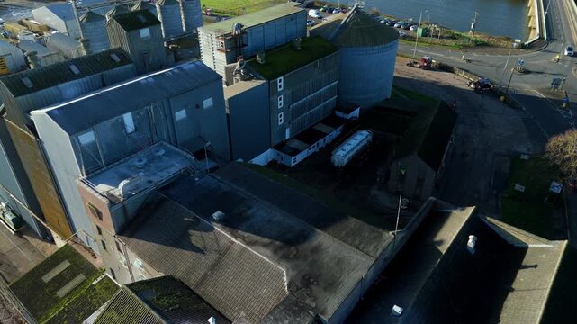 Aerial view of industrial and agricultural factory on the River Ouse Banks in Downham Market. Sunny winter day, rural landscape. Manufacturing and fertiliser production UK