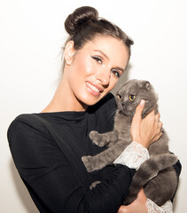 young woman with a cat. Animal. Cat. Photo. Smiling woman. Funny 