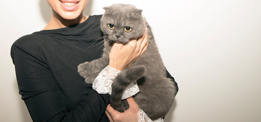 Woman hugging her kitten. Cat. Photo. Happy day. Background. 