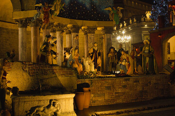 Roma , Italia , San Peter Square 12-18-2025. Nighttime Nativity Scene With Starry Arch, Festive Market Square, And Large Christmas Tree