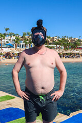 Man in Snorkeling Mask Standing on a Pontoon in the Red Sea, Embracing Adventure Beauty of Underwater Exploration.