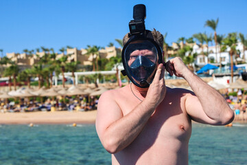 Man Snorkeling Mask Standing on a Pontoon in the Red Sea, Embracing Adventure and the Beauty of Underwater Exploration.