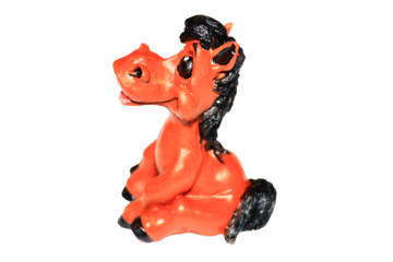 A toy horse sits atop a white surface, ready for play or display