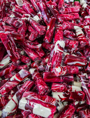 Pile of sweet green toffee called "Dodol Garut" in clear plastic wrappers. A famous Indonesian souvenir from Garut, West Java,  with a sticky texture and modern colorful look.
