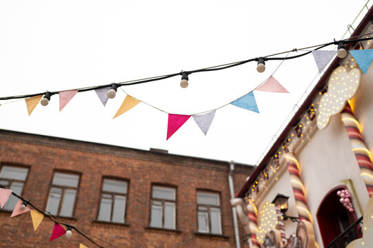 Festive outdoor bunting against brick building and bright sky