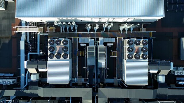 Close up aerial drone view of large scale data center, AI cloud and quantum computing cooling infrastructure. Fans and ventilation, Milton Keynes, UK