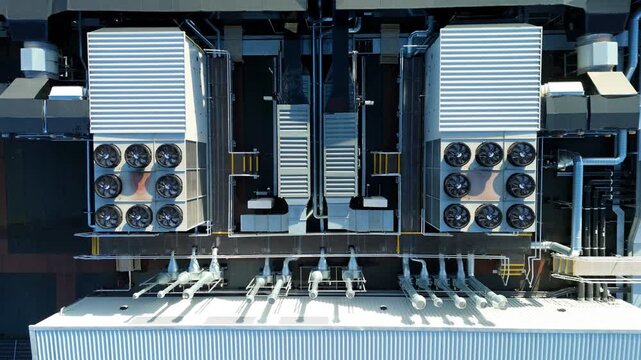 Close up aerial drone view of large scale data center, AI cloud and quantum computing cooling infrastructure. Fans and ventilation, Milton Keynes, UK