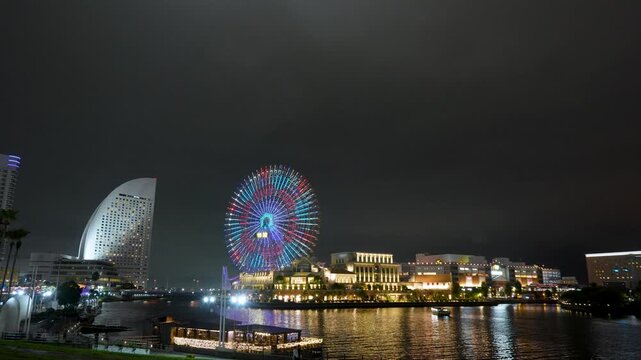 Night scene of Yokohama Minato Mirai in autumn. It shows the Cosmo Clock 21 Ferris wheel, illuminated skyscrapers, and the historic Nippon Maru ship.