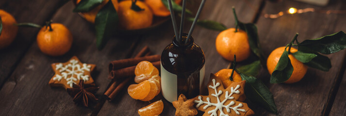 Banner. Christmas fragrance with citrus, cinnamon, anise, vanilla, gingerbread cookies. Home comfort, coziness, aromatherapy. Winter time. Cozy interior with aroma perfume diffuser in the living room