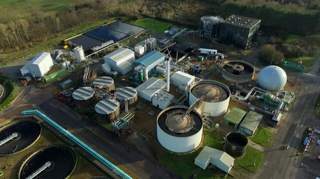 Aerial drone view of large scale Severn Trent waste water treatment plant. Sewage works Anglian water, removing waste sanitation, Milton Keynes, United Kingdom.