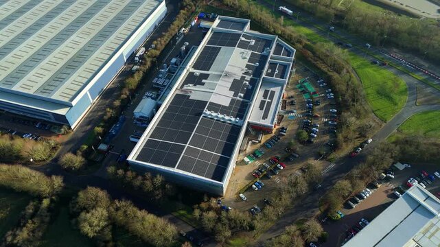 Aerial view of Industrial factory rooftop with solar panels and hardware components, piping and cooling infrastructure in Milton Keynes, UK