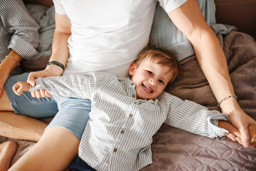 Fototapeta premium Joyful Toddler Laughing While Playing With Father