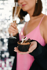 Chocolate Cupcake With Burning Candle In Hand