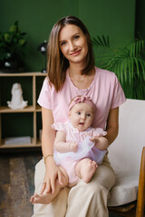 Tender Mother Holding Baby Girl In Pink Outfit
