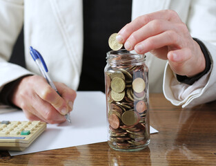 saving coins with money to pay bills having the intention of calculating raising more money to be wealthy stock image stock photo