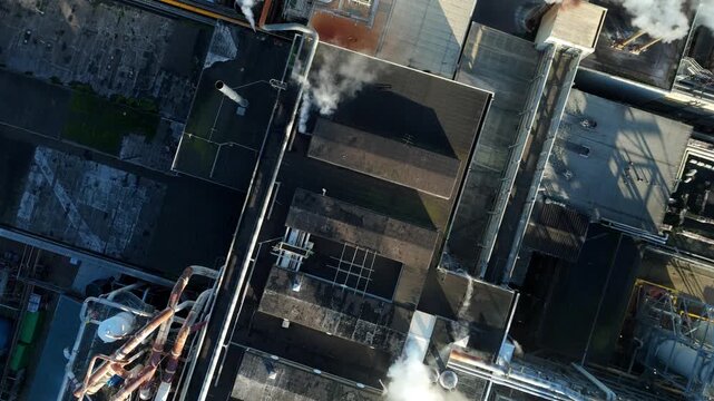 Aerial drone footage of sugar production industry with chimneys silos and factory buildings near Wissington