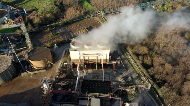 Top down aerial view of industrial cooling fans and smoke plumes with cooling water recirculation from sugar processing and production in Wissington, United Kingdom 