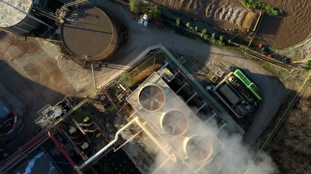 Top down aerial view of industrial cooling fans and smoke plumes with cooling water recirculation from sugar processing and production in Wissington, United Kingdom 
