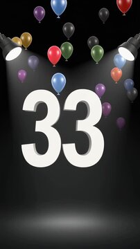 Number 33 in the spotlights with balloons in the background. Festive scene for birthday or anniversary party