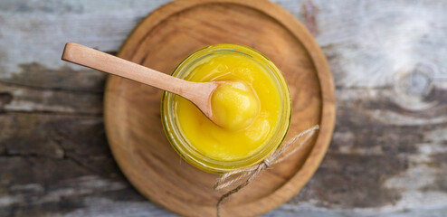 Ghee in a jar in a meadow. Selective focus.