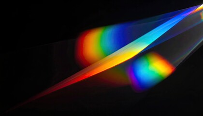 Close-up of refracted light creating a spectrum of colors against a black backdrop
