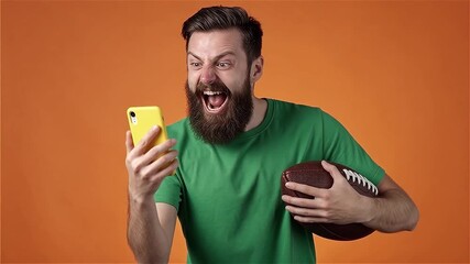 Excited fan with football & smartphone: Intense sports moment. - Powered by Adobe